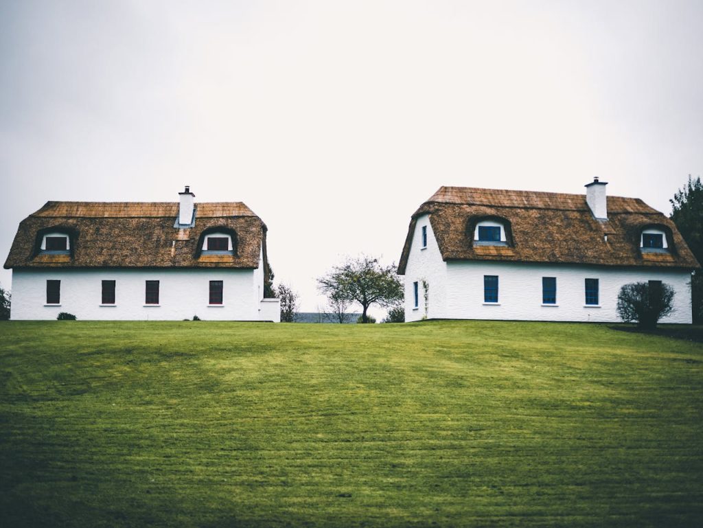 pexels photo 3466361 Two traditional Irish farmhouses on a lush green landscape in Kinvarra, Ireland.